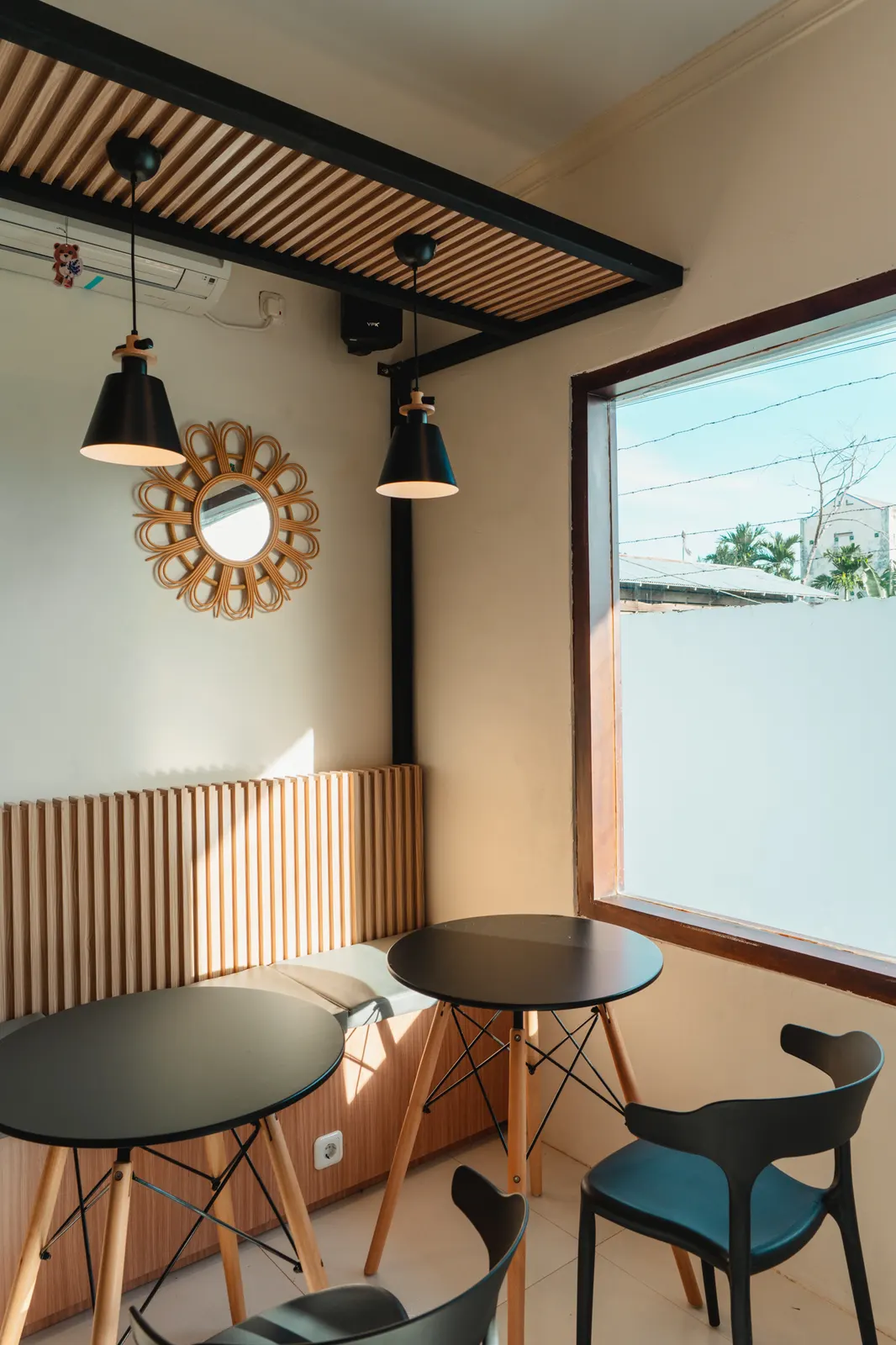 Corner tables under a rattan mirror